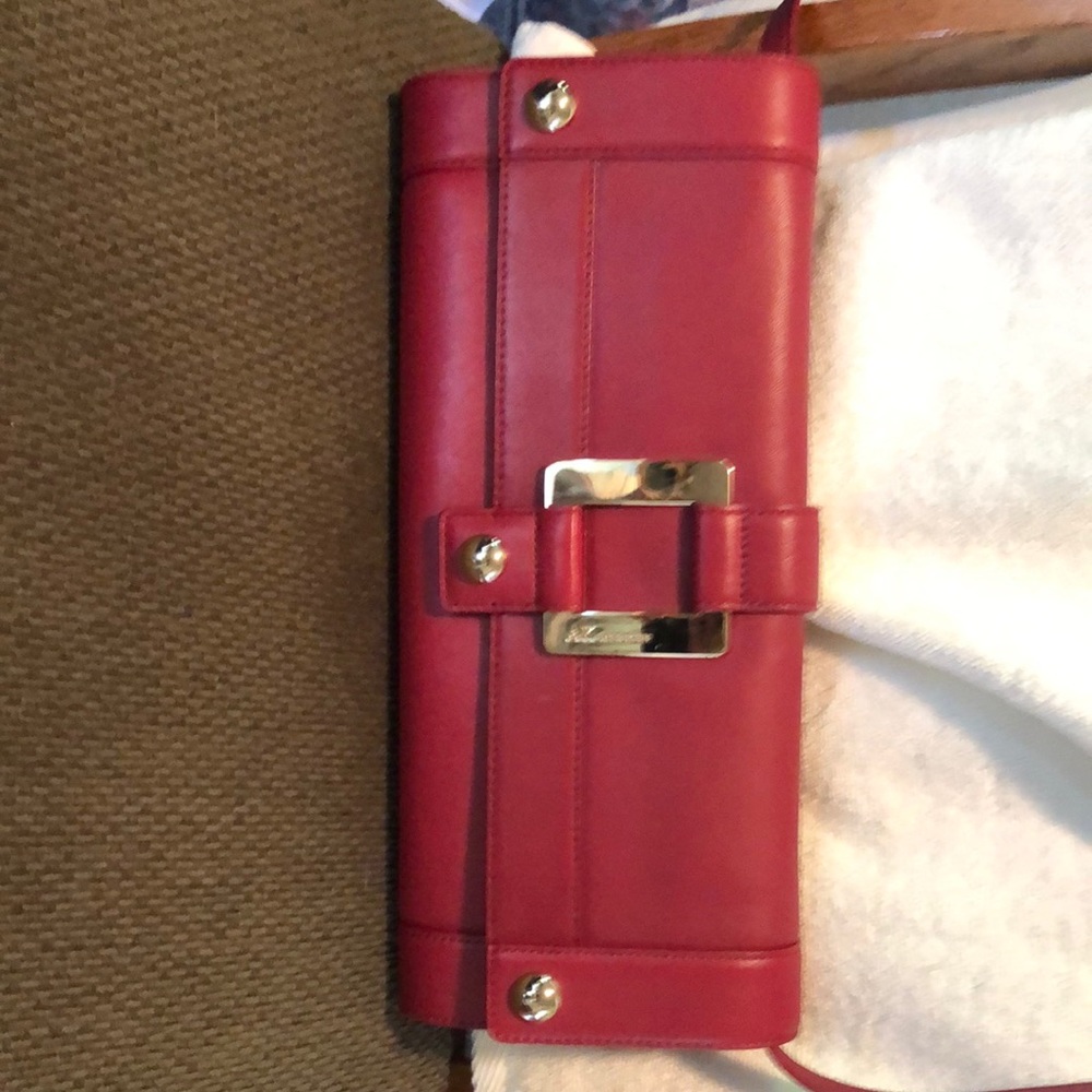 Anne Klein red clutch purse with strap in new condition